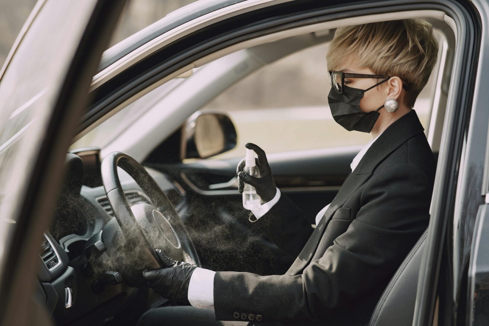 A person in a car wearing a mask